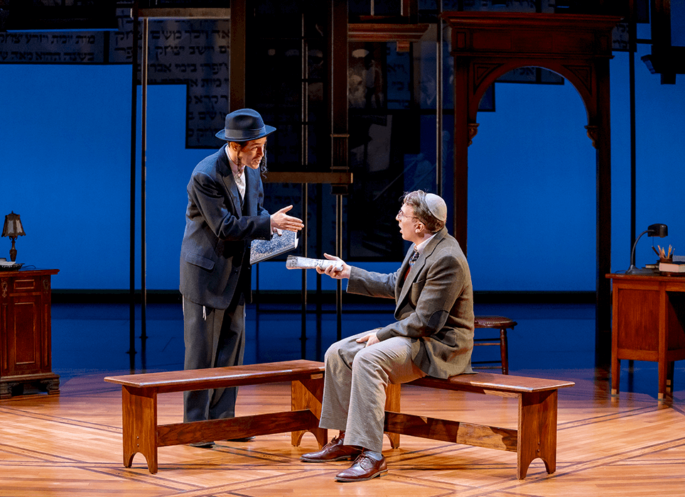 Two young men in a Jewish temple set having a discussion.