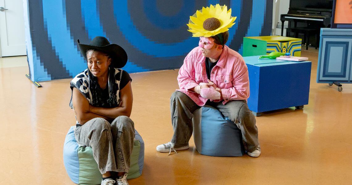 Characters dressed like a flower and cowboy on beanbags.
